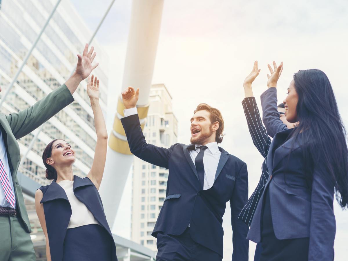 close up business people hands together teamwork concept